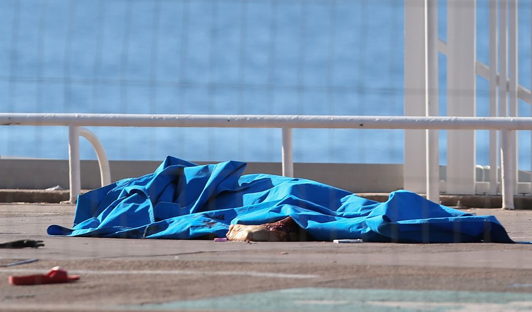 Bodies of victims covered by sheets remained at the scene of the attack early Friday.