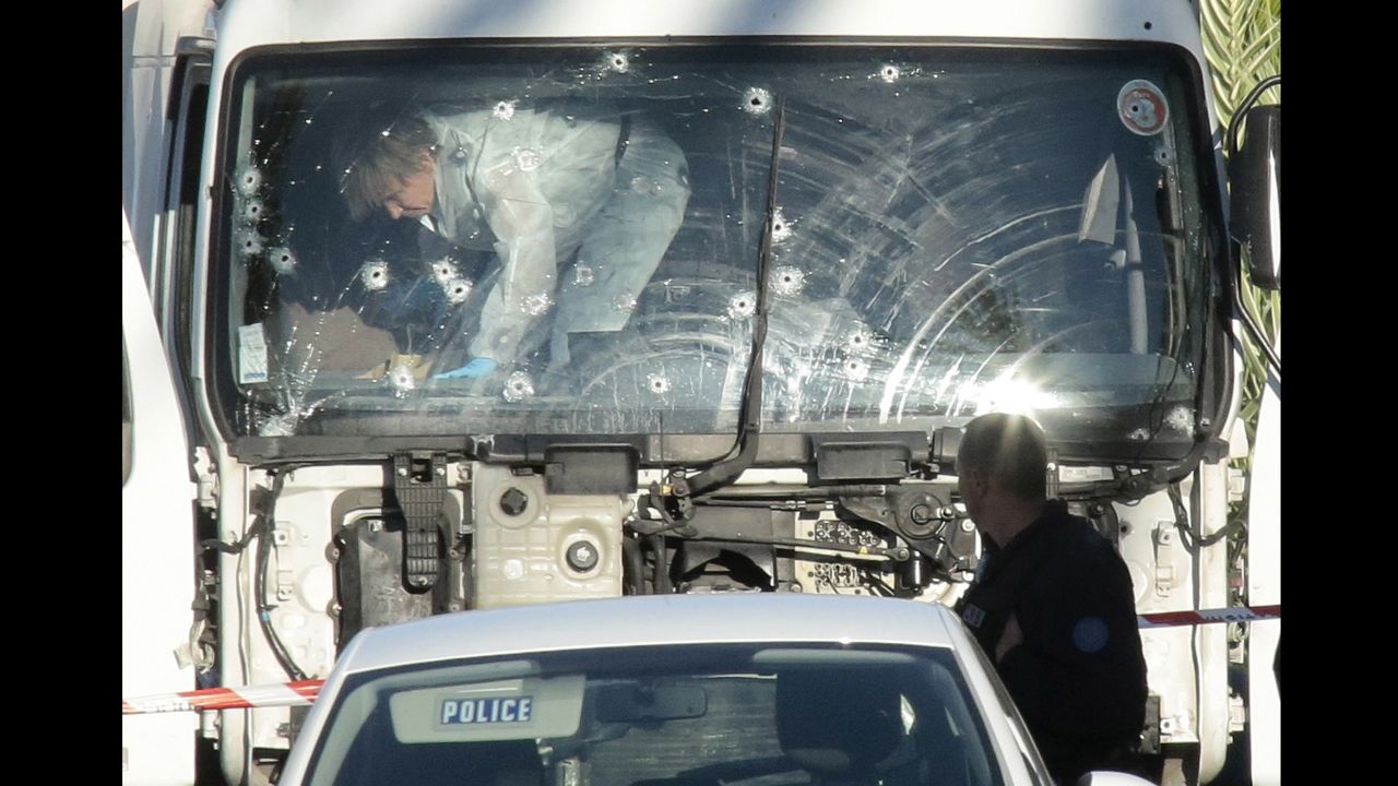 Forensics investigators examine a truck at the scene of the attack.