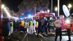 Police officers, firefighters and rescue workers are seen at the site of an attack on July 15, 2016, after a truck drove into a crowd watching a fireworks display in the French Riviera town of Nice.
A truck ploughed into a crowd in the French resort of Nice on July 14, leaving at least 60 dead and scores injured in an "attack" after a Bastille Day fireworks display, prosecutors said on July 15.  / AFP / Valery HACHE        (Photo credit should read VALERY HACHE/AFP/Getty Images)