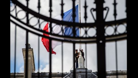 French Republican guards place the French flag at half-staff at the Elysee Palace in Paris on July 15.