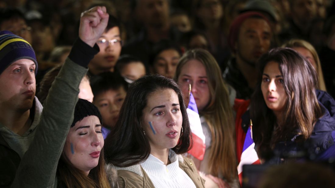 People sing the French national anthem at a July 15 vigil in Sydney.