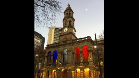 The town hall in Adelaide, Australia, is lit up in the colors of the French flag.