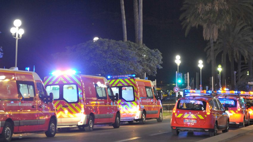 Fire department ambulances and vehicles are parked near the scene of an attack after a truck drove on to the sidewalk and plowed through a crowd of revelers who'd gathered to watch the fireworks in the French resort city of Nice, southern France, Friday, July 15, 2016. A spokesman for France's Interior Ministry says there are likely to be "several dozen dead" after a truck drove into a crowd of revelers celebrating Bastille Day in the French city of Nice. (AP Photo/Christian Alminana)