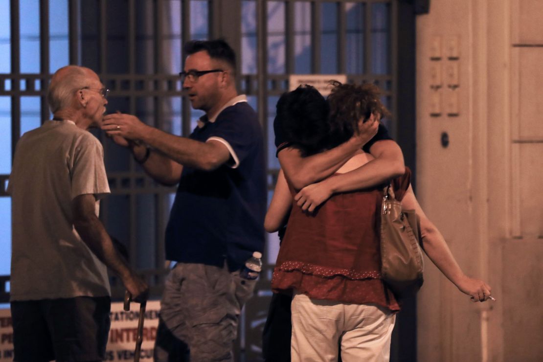 People in the French towon of Nice comfort each other after an attack taht killed at least 84 people. 