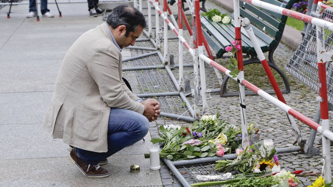 A man near the French Embassy at Paris square in Berlin pays tribute to the victims.