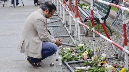 A man near the French Embassy at Paris square in Berlin pays tribute to the victims of the Nice attack.