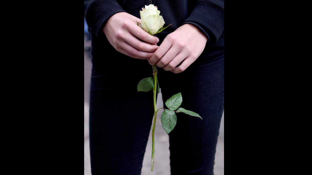 A pupil holds a white rose on the premises of the Paula Fuerst comprehensive school in Berlin, Germany.