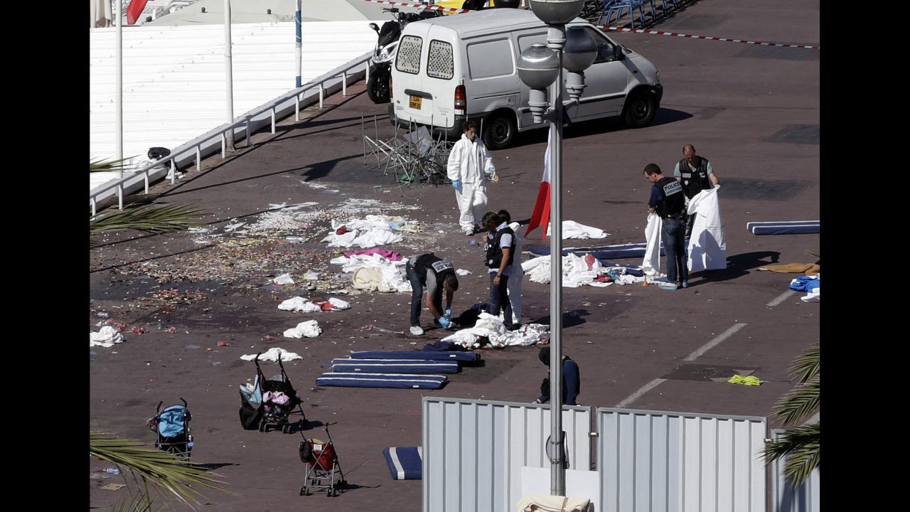 Police researchers inspect the scene where a truck crashed late 14 July 2016 into the crowd during the Bastille Day celebrations in Nice, France