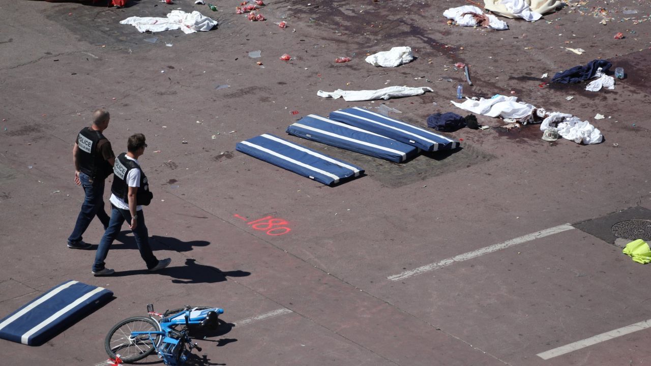 Policemen walk on the site where a truck drove into a crowd watching a fireworks display on the Promenade des Anglais seafront in the French Riviera town of Nice on July 15, 2016.
An attack in Nice where a man rammed a truck into a crowd of people left 84 dead and another 18 in a "critical condition", interior ministry spokesman Pierre-Henry Brandet said Friday. An unidentified gunman barrelled the truck two kilometres (1.3 miles) through a crowd that had been enjoying a fireworks display for France's national day before being shot dead by police.
 / AFP / Valery HACHE        (Photo credit should read VALERY HACHE/AFP/Getty Images)