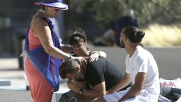 Relatives of the victims of the Bastille Day attack comfort each other as they gather in front of Pasteur Hospital in Nice, southern France on Friday, July 15, 2016. 