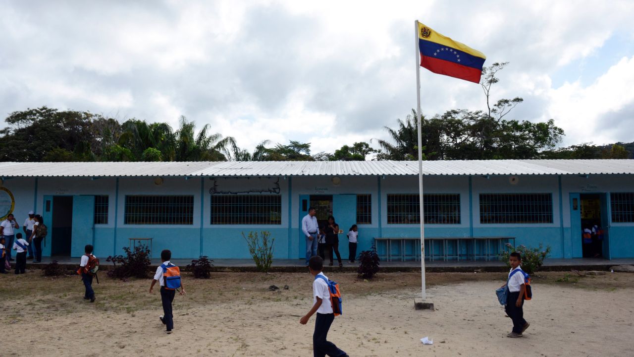 Venezuelan boys and girls from different native ethnic groups, are pictured at the Esperanza multi-ethnical school in Puerto Ayacucho, in the Venezuelan state of Amazonas, on October 24, 2013. Children from the three ethnic groups attending the Esperanza school, are tought in Spanish.   AFP PHOTO/Leo RAMIREZ        (Photo credit should read LEO RAMIREZ/AFP/Getty Images)