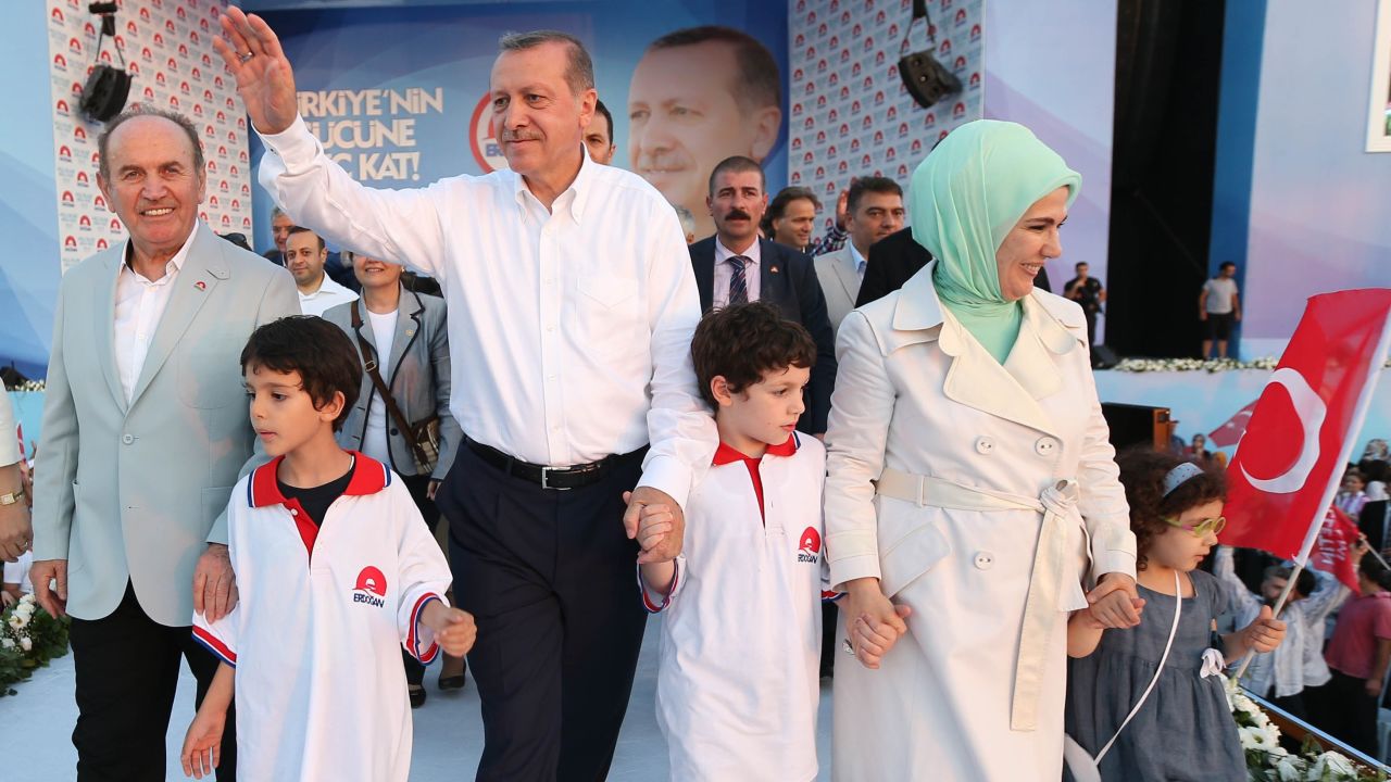 Erdogan, his wife Emine, his grandchildren and Istanbul Metropolitan Municipality Mayor Kadir Topbas, left, greet the crowd at a presidential election rally in Istanbul on August 3, 2014.
