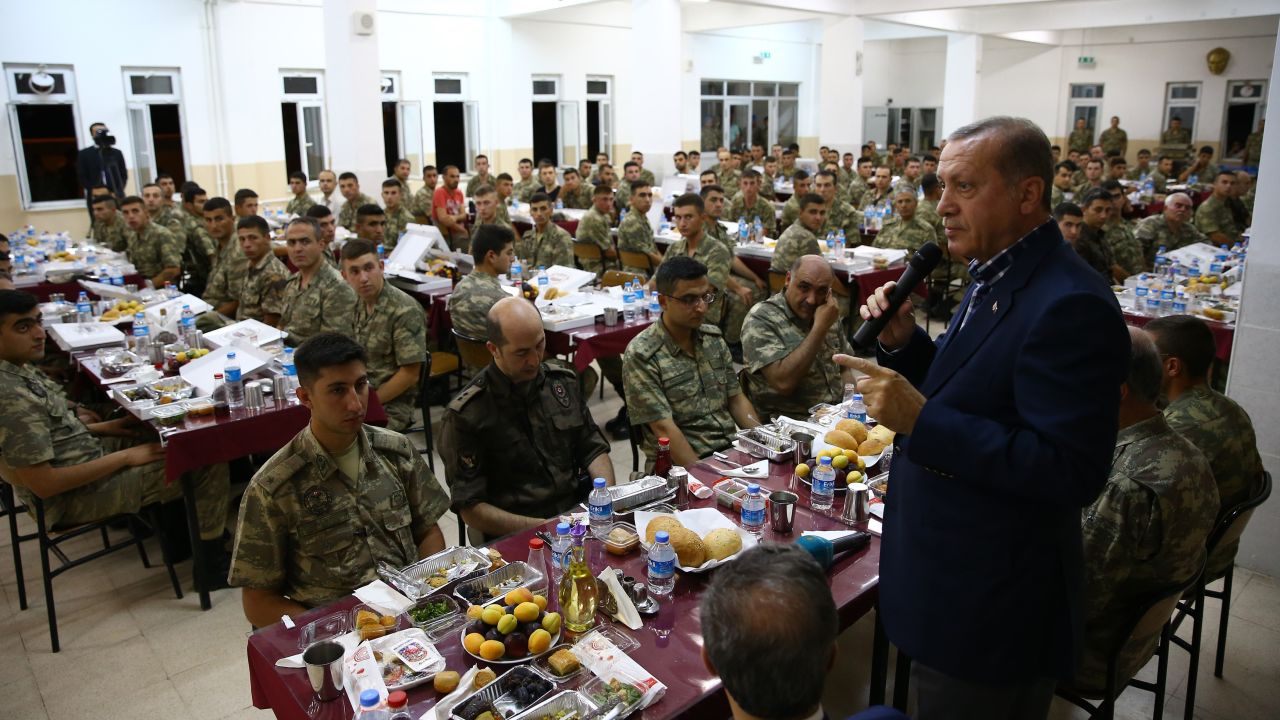 Erdogan, right, attends an Iftar dinner during his visit to the Tank Battalion campus in the Cizre district of Sirnak, Turkey, on Saturday, June 25.