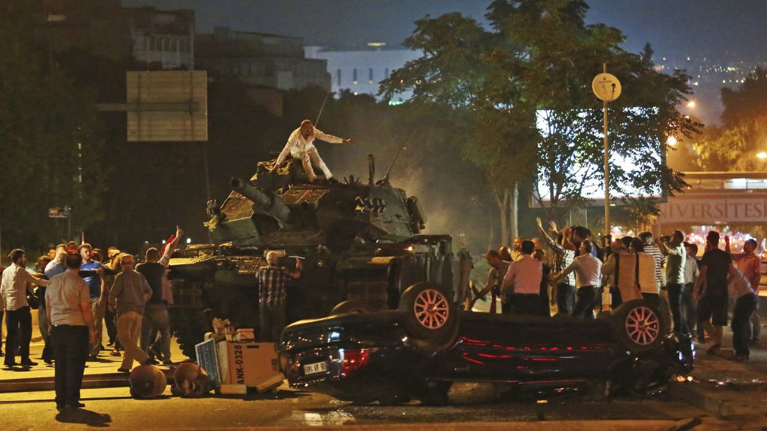 Tanks move into position as Turkish citizens attempt to stop them in Ankara.