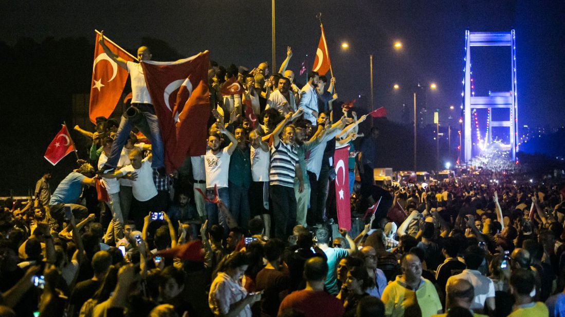 People take to the streets near the Fatih Sultan Mehmet Bridge during clashes with military forces in Istanbul. 