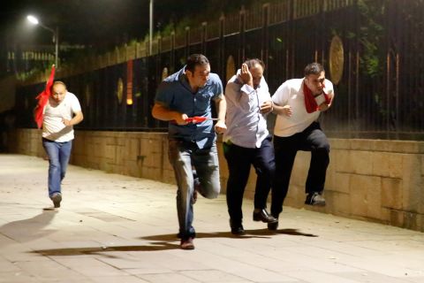 People escape the clashes in Ankara early Saturday. 