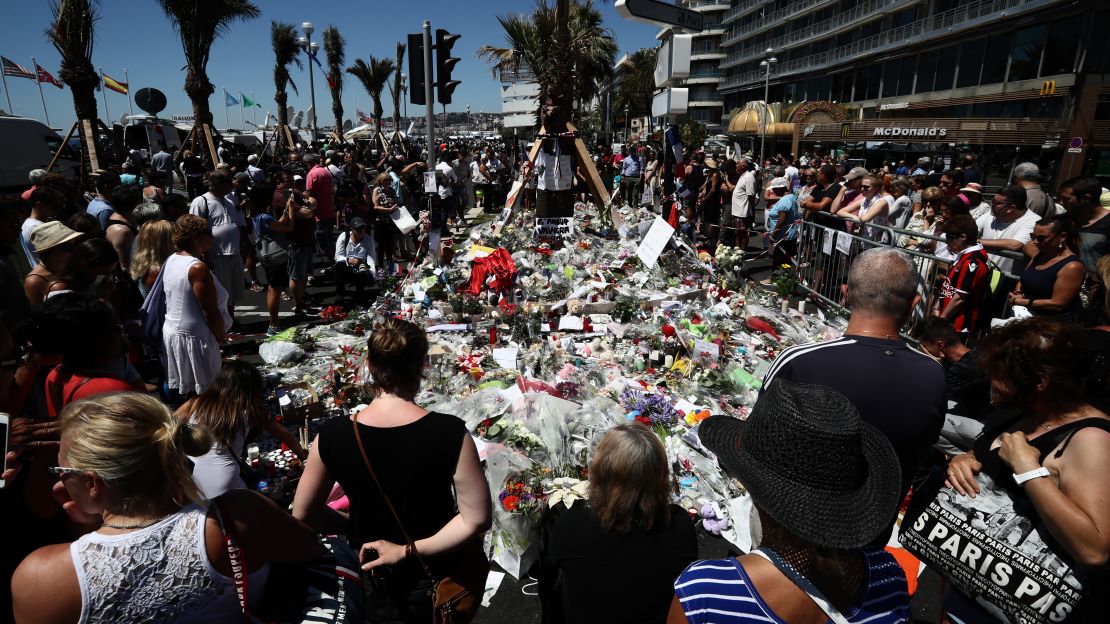 People gather and lay tributes on the Promenade des Anglais on July 16, 2016 in Nice, France.