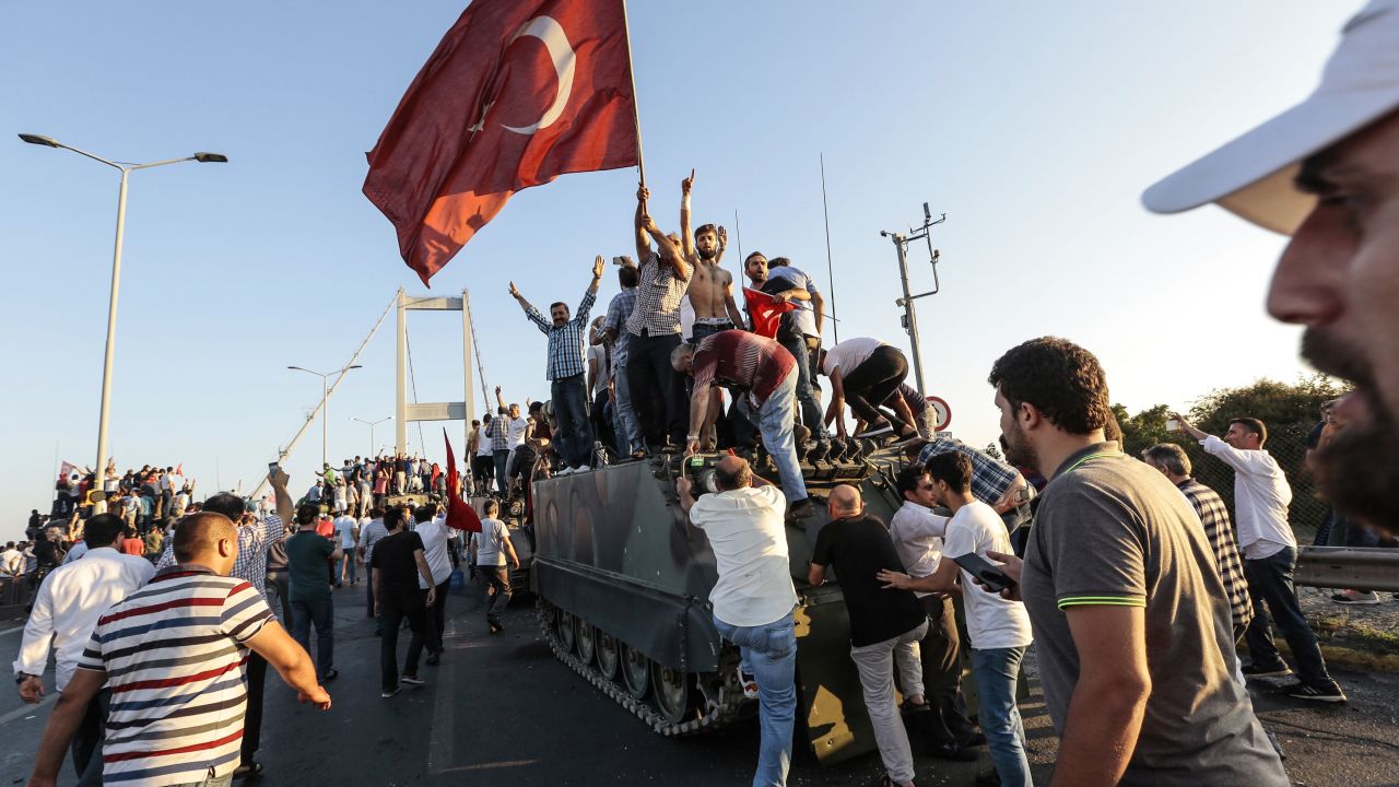 The Turkish President's supporters celebrate after soldiers surrendered on Istanbul's Bosphorus Bridge.