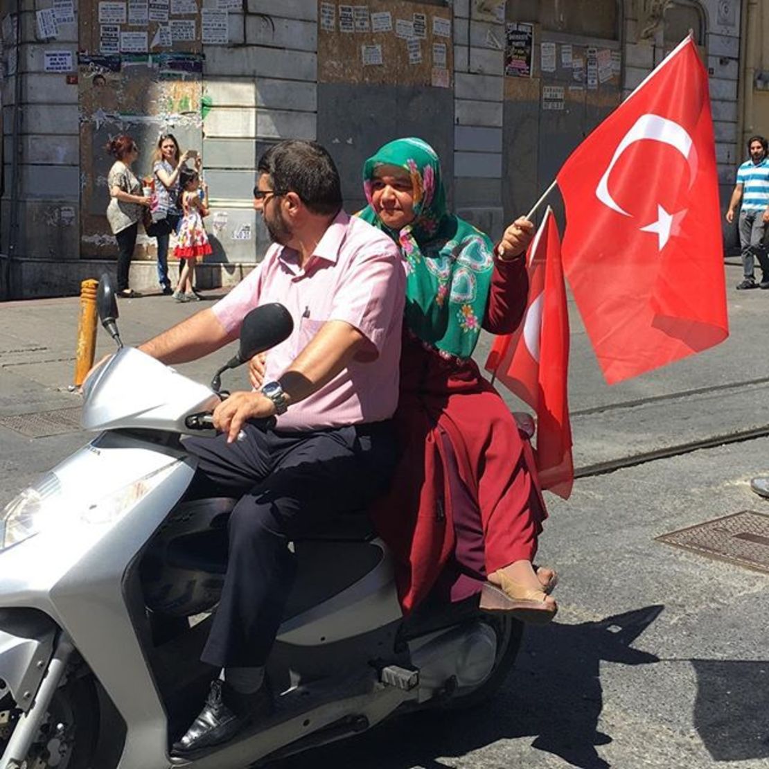 A scooter joins demonstratord headed toward Taksim Square.
