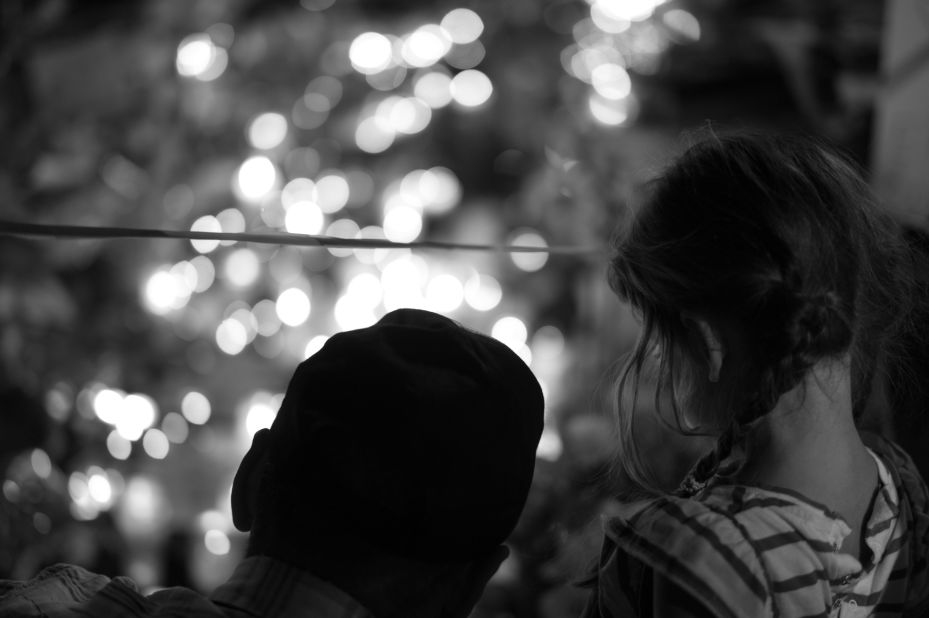 A man and a child look at a memorial for victims of the attack. Sanguinetti spent time photographing near the Promenade des Anglais, the area where the tragedy unfolded.