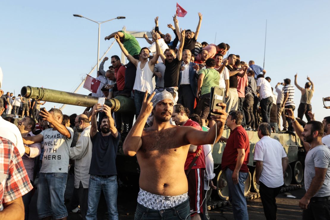 Erdogan supporters capture a military tank.