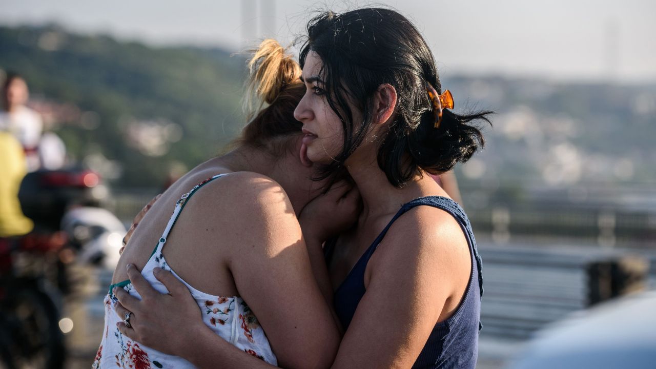 Women react after people took over a military position on the Bosphorus Bridge in Istanbul.