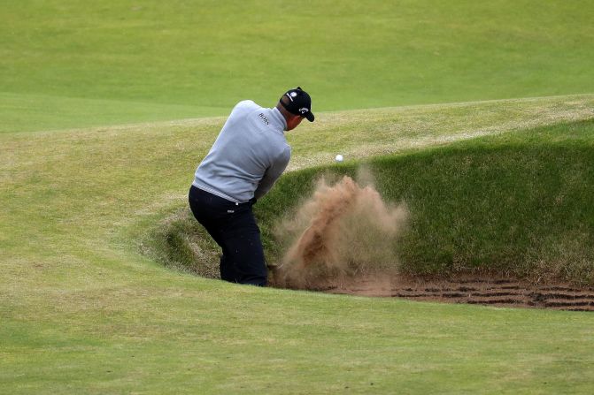Stenson has to play out of one of the many steep bunkers at Troon on the 7th hole during his third round 68. 