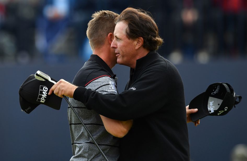 Stenson and Mickelson embrace after their incredible final round showing with the Swede equaling the major championship record round with an eight-under 63. Mickelson shot a 65. 