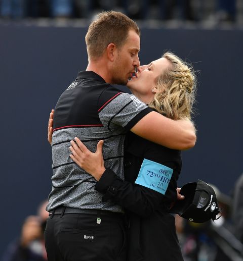 Stenson kisses his wife Emma on the 18th green after sealing his victory and first major.