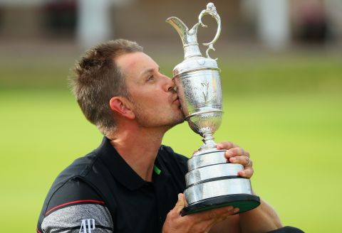 Henrik Stenson gets his hands on the Claret Jug after a stunning performance at Royal Troon to beat Phil Mickelson by three shots.