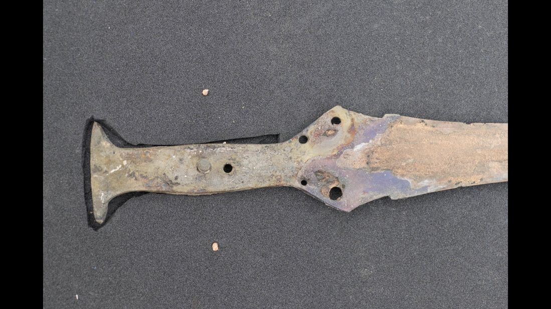 A Wilburton-type sword is seen with rivets and fragments of lead pommel.