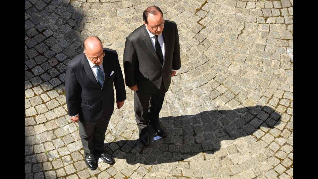 French President Francois Hollande, right, and Interior Minister Bernard Cazeneuve take part in the observation of a minute's silence on July 18 at the Interior Ministry in Paris.