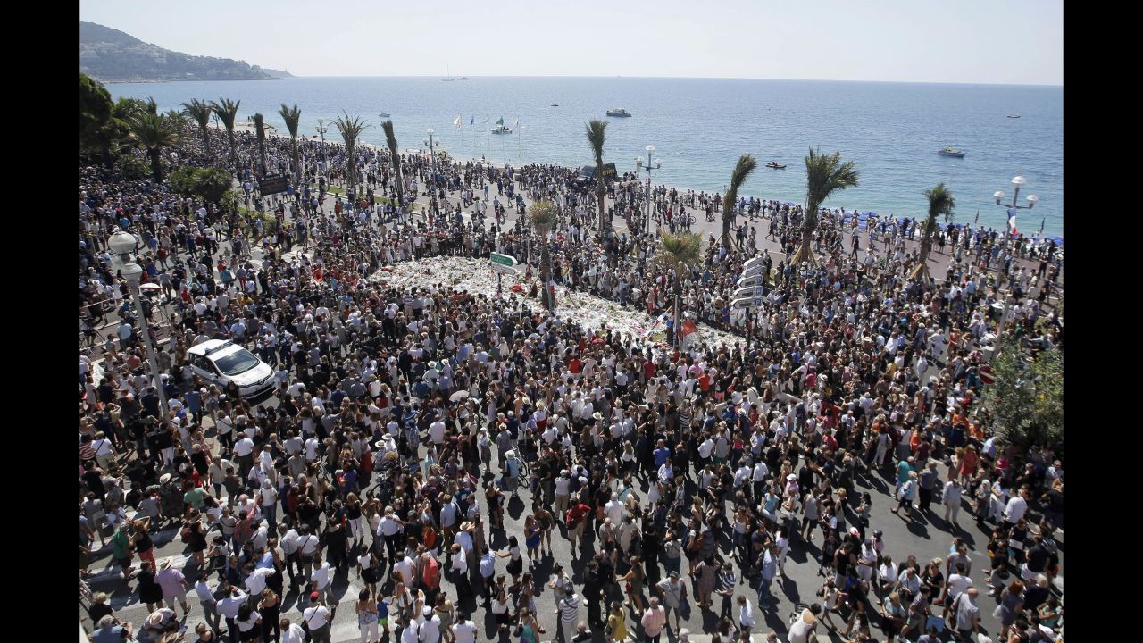 People observe a national moment of silence on Monday, July 18, in Nice near where a truck mowed through crowds on the Promenade des Anglais during Bastille Day celebrations. France is holding a national moment of silence to honor the 84 victims killed in the truck rampage.
