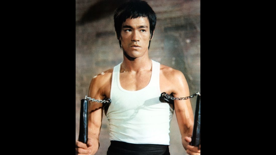 Bruce Lee with his signature weapon, the dreaded nunchakus. The weapon was actually introduced to him by his training partner. Lee's ability to learn it so quickly amazed his partner.<br />. 