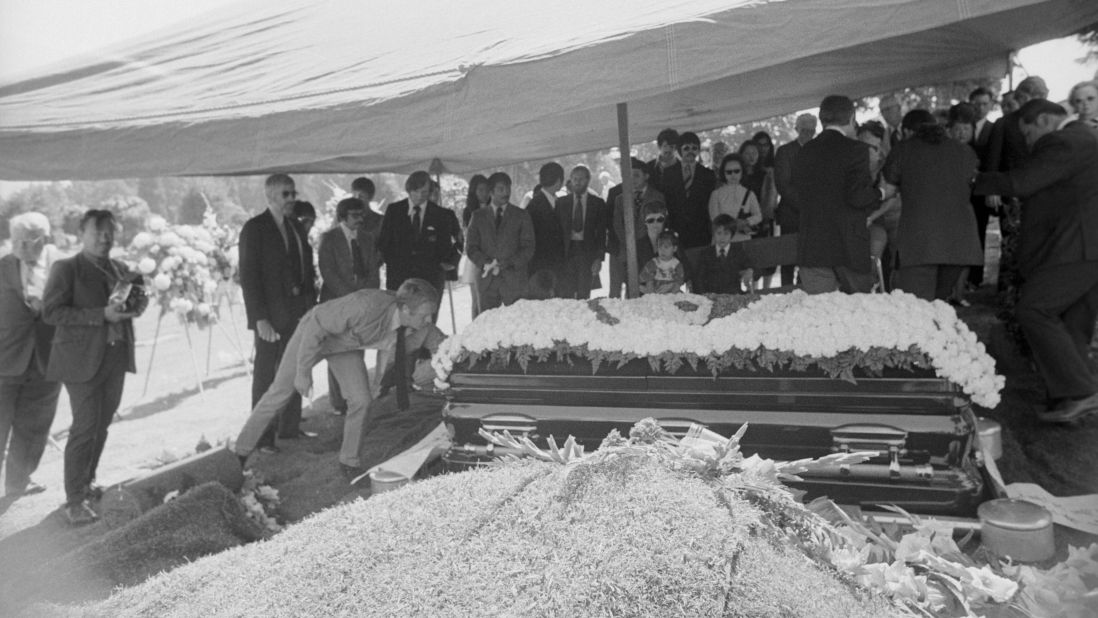 Actor Steve McQueen straightens the sign on the casket at Bruce Lee's funeral in 1973. Before he became a star, Lee taught the martial arts to celebrities such as McQueen and actor James Coburn.