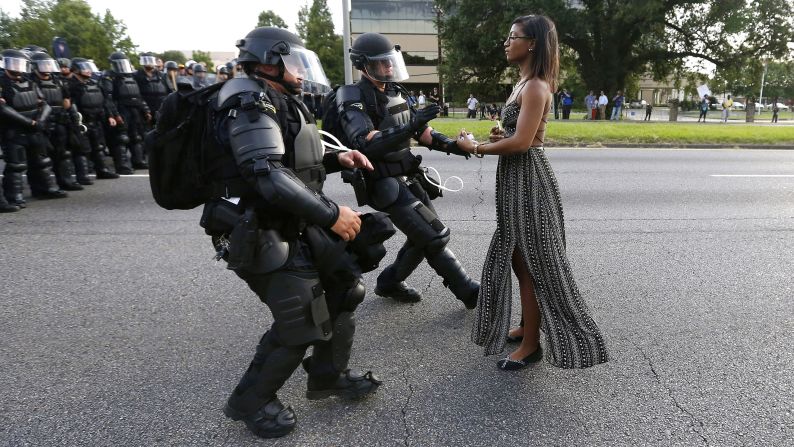 Protester Ieshia Evans is detained by law enforcement officers near the police headquarters in Baton Rouge, Louisiana, on Saturday, July 9. Evans was among dozens of people protesting <a href="index.php?page=&url=http%3A%2F%2Fwww.cnn.com%2F2016%2F07%2F07%2Fus%2Fbaton-rouge-alton-sterling-shooting%2F" target="_blank">the death of Alton Sterling,</a> who was fatally shot by police just a few days earlier. Click through the gallery to see memorable images from other protests throughout history.