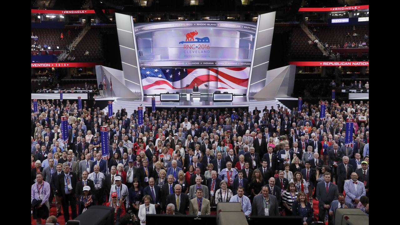 Delegates stand and turn toward the camera for an official photo on Monday.