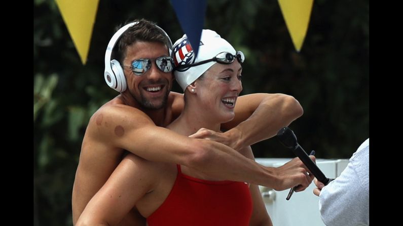 Michael Phelps hugs Allison Schmitt as she is interviewed Saturday, July 16, in San Antonio. It was media day for the U.S. Olympic swimming team.
