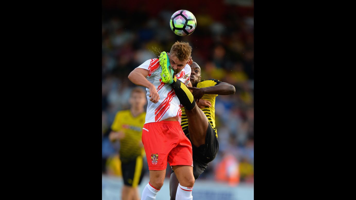 Watford's Allan Nyom, right, competes for a ball with Stevenage's Matt Godden during a preseason friendly match in Stevenage, England, on Thursday, July 14.