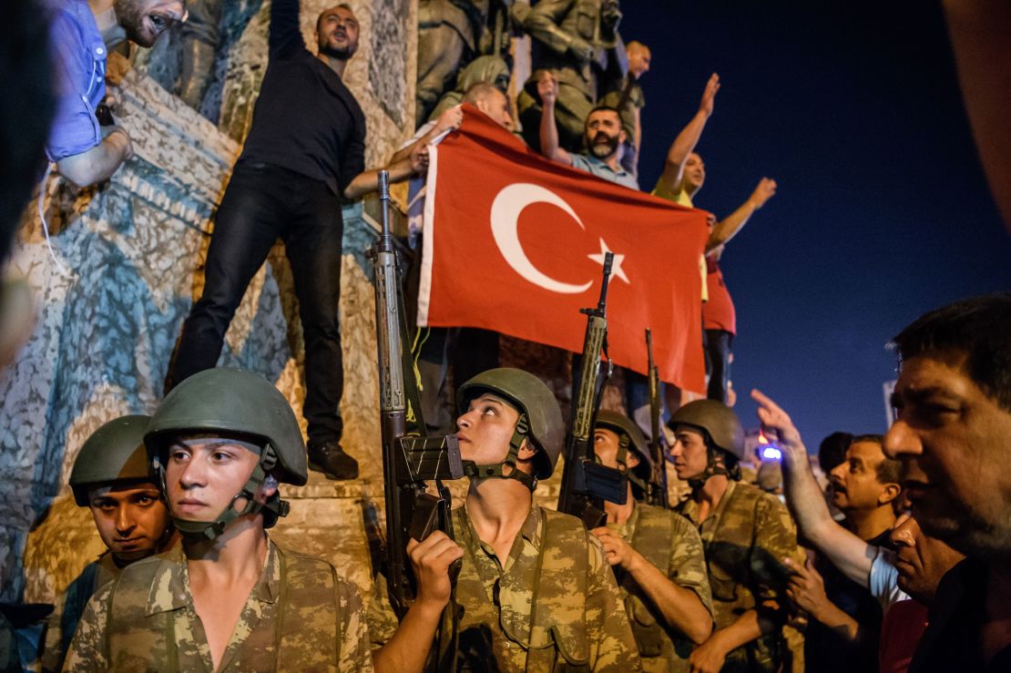 Turkish solders stay with weapons at Taksim square as people protest against the military coup in Istanbul.