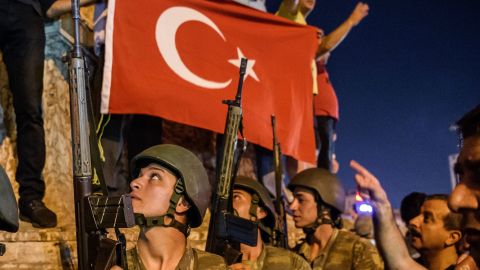 Turkish solders stay with weapons at Taksim square as people protest against the military coup in Istanbul.