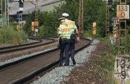 Police officers walk along train tracks in Wuerzburg, southern Germany, on Tuesday, July 19, a day after a man attacked train passengers with an ax. 