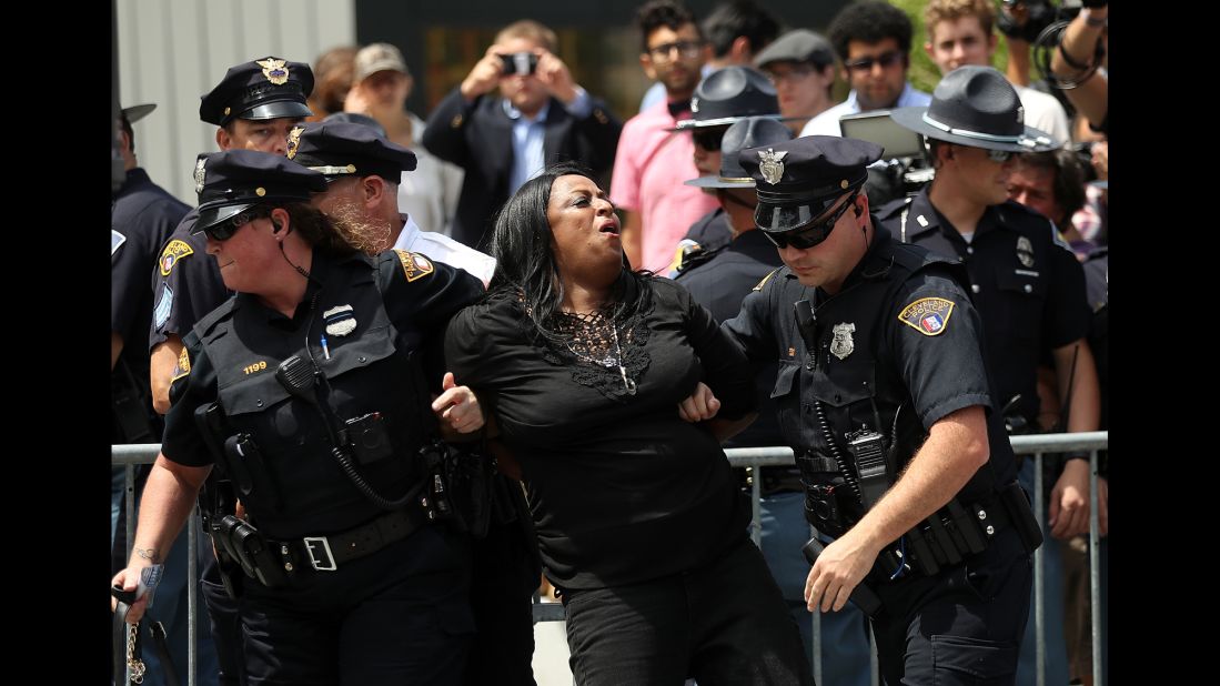 Police officers detain a protester in Public Square on Monday.