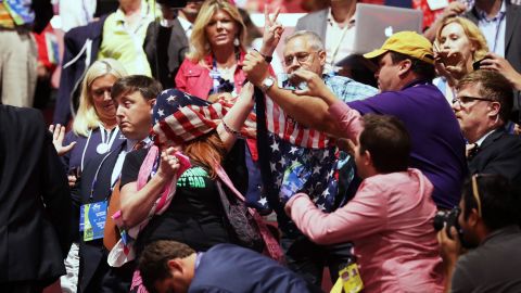 A member of the activist group Code Pink protests inside the arena during Carson's speech.