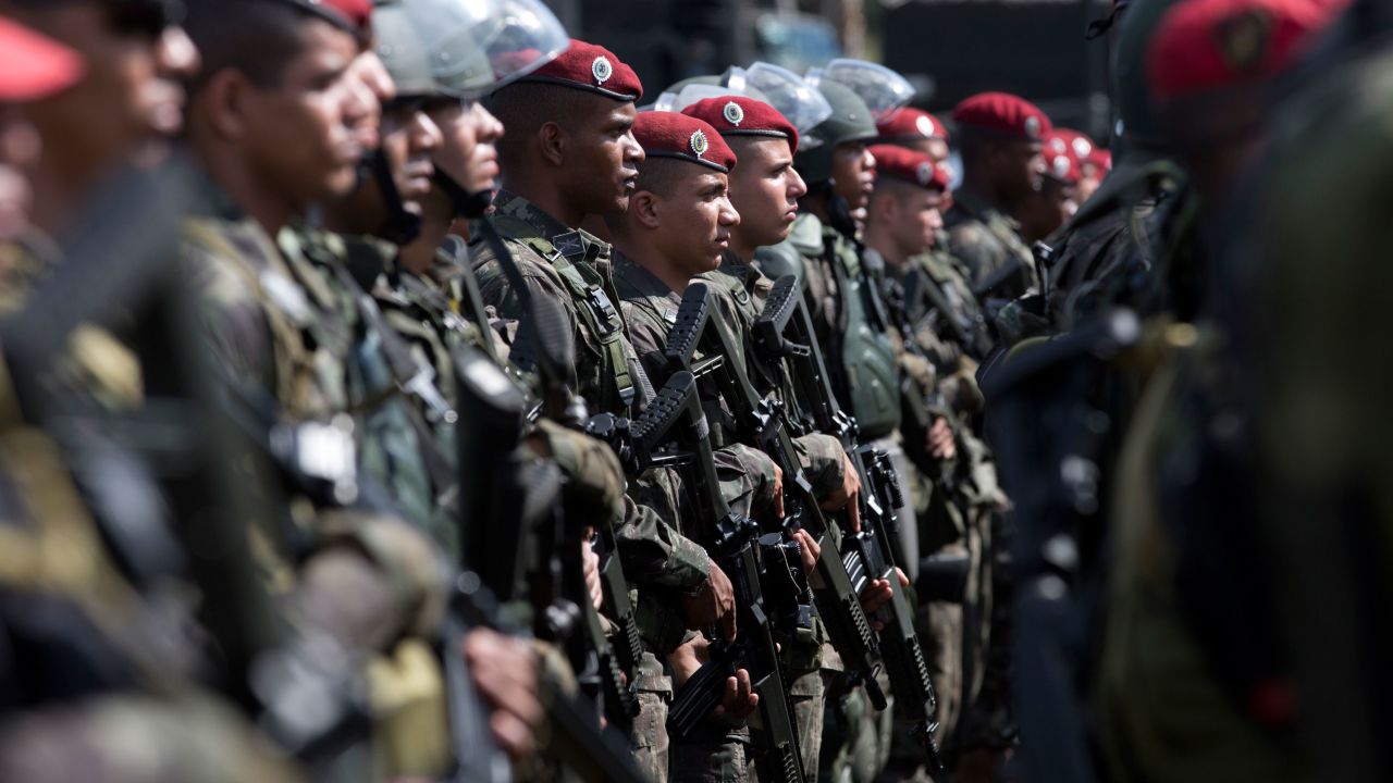 Brazilian Paratrooper Brigade soldiers, who will be deployed during the Olympic games, are presented during a ceremony in Rio de Janeiro, Brazil, Friday, July 8, 2016. Roughly twice the security contingent at the London Olympics will be deployed during the August games in Rio, which are expected to draw thousands of foreigners to a city where armed muggings, stray bullets and turf wars between heavily armed drug gangs are routine. (AP Photo/Silvia Izquierdo)