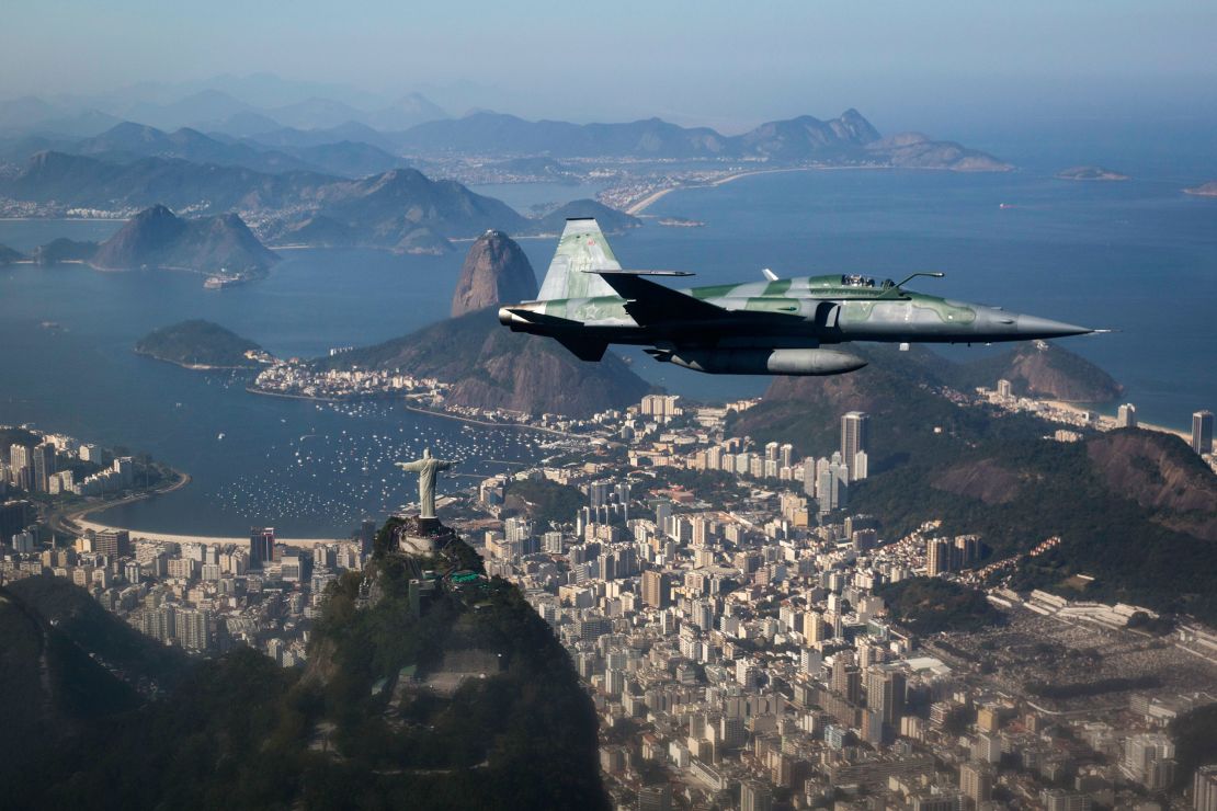 An F-5 fighter flies over Rio during a Brazilian Air Force security demonstration before the Games.