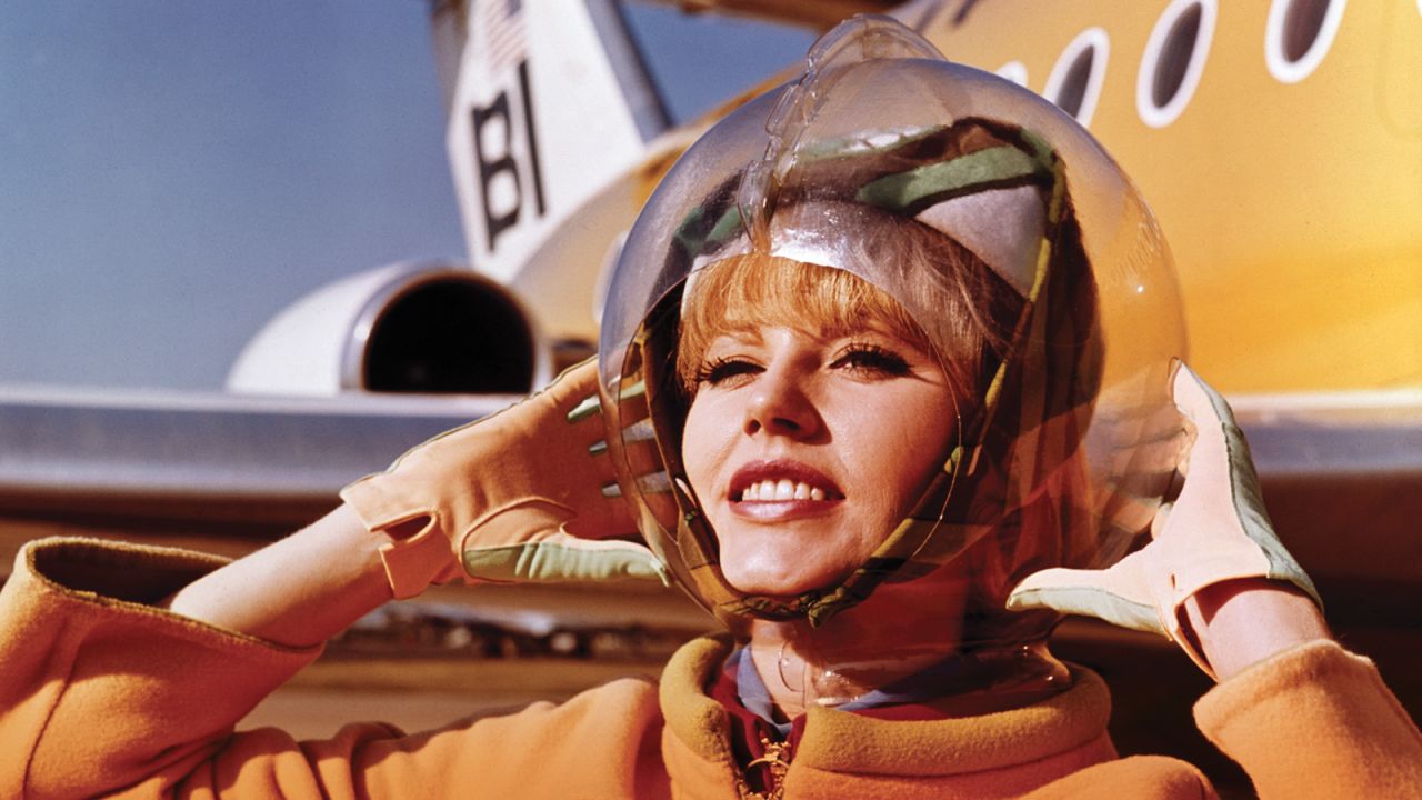 In a 1965 look designed by Emilio Pucci, a Braniff International Airways hostess displays her space bubble helmet. No, these were not very practical. 