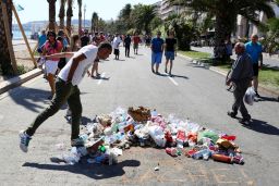 A man spits on the site in Nice where police killed the attacker.