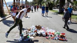 A man spits on July 18, 2016 on the Promenade des Anglais seafront in Nice, at the site where Mohamed Lahouaiej-Bouhlel, a 31-year-old Tunisian who drove a truck into a crowd watching a fireworks display on Bastille Day, was killed by the police. The message reads "coward".
France was set to hold a minute's silence on July 18, 2016 to honour the 84 victims of the Nice truck attack, but a period of national mourning was overshadowed by bickering politicians. Church bells will toll across the country, and the country will fall silent at midday, a now grimly familiar ritual after the third major terror attack in 18 months on French soil. / AFP / Valery HACHE        (Photo credit should read VALERY HACHE/AFP/Getty Images)