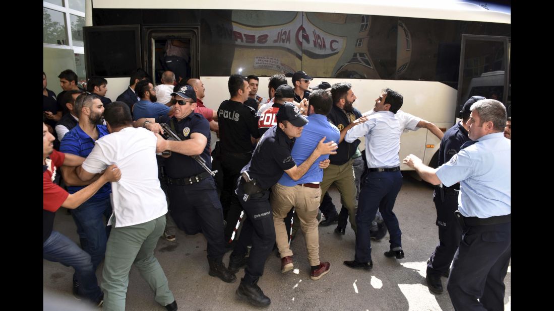 Police try to stop people from attacking a judge, suspected in the failed coup plot, in Erzurum, Turkey on Tuesday, July 19. Turkey has fired or suspended about 50,000 people as the government intensifies a crackdown following last weekend's failed coup attempt. Teachers, journalists, police and judges have been affected. 